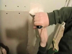 Dampen drywall tape and paste onto patch