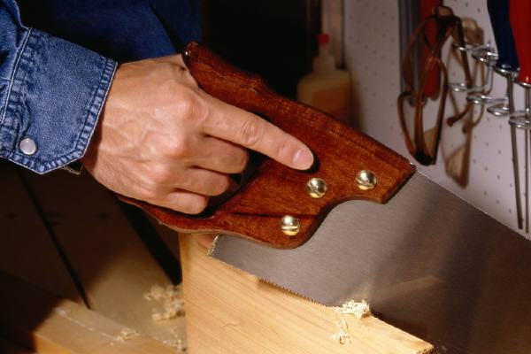 Handsawing a board