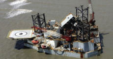 An oil platform ripped from its mooring in the Gulf of Mexico rests by the shore of Dauphin Island, Alabama. Photograph: Peter Cosgrove/AP
